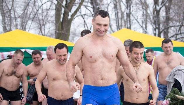 Kyiv city mayor Vitali Klitschko dives into water to celebrate Orthodox Epiphany. Photos