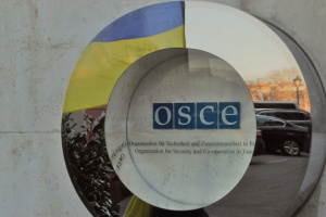 OSCE observers cross through road inside disengagement area near Zolote
