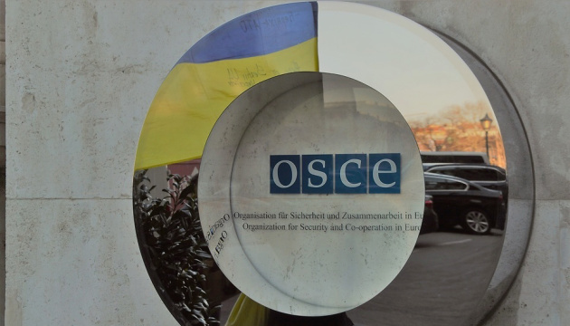 OSCE observers cross through road inside disengagement area near Zolote