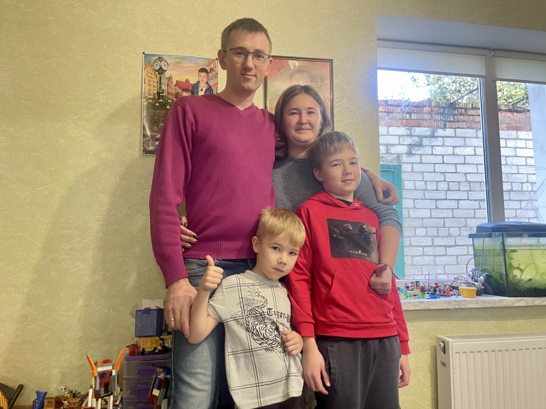Oleksii, Zina, Andrii, and Kostia at home